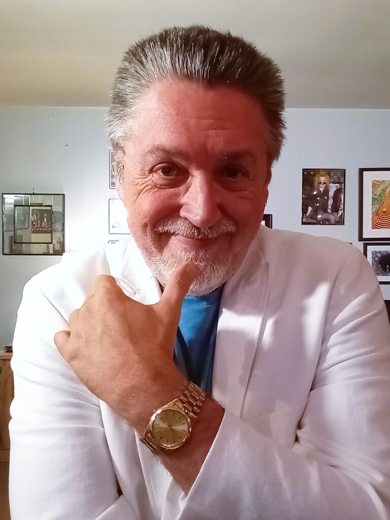 Me Wearing a white suite with blue t shirt and gold watch
