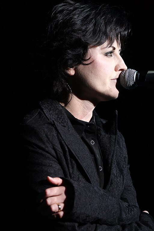 Dolores O'Riordan on stage with a microphone