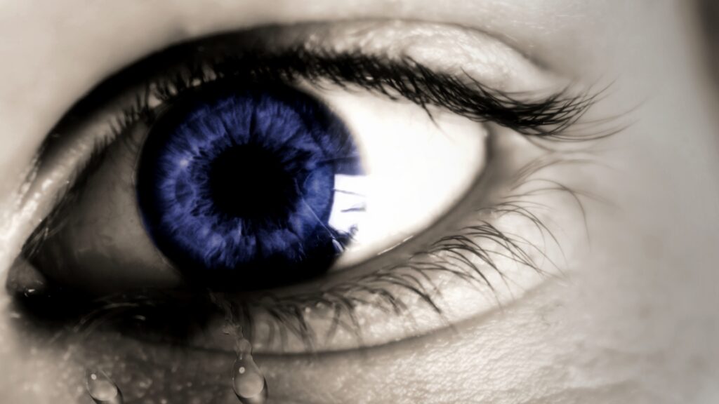 Blue eye with tears flowing out