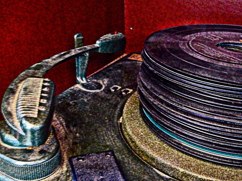 45 speed records stacked on a record player