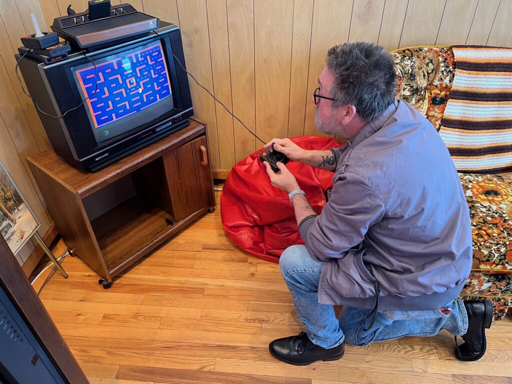 Me playing pac pan on a vintage atari 2600 and vintage tv.