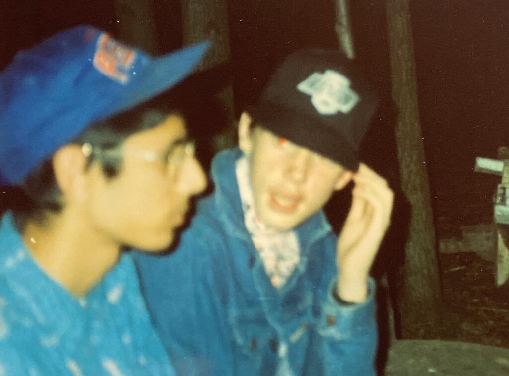 Jeremy and a friend wearing baseball caps