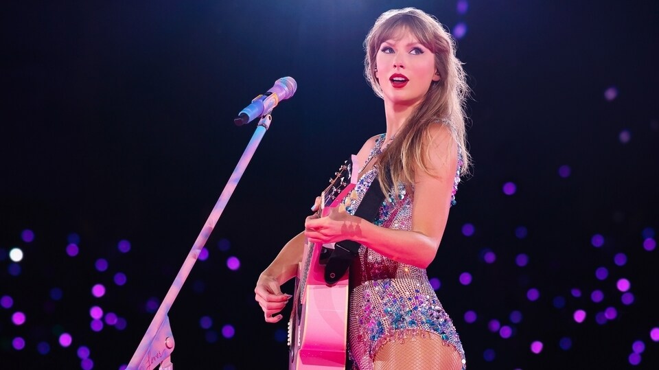 Taylor Swift on stage with guitar