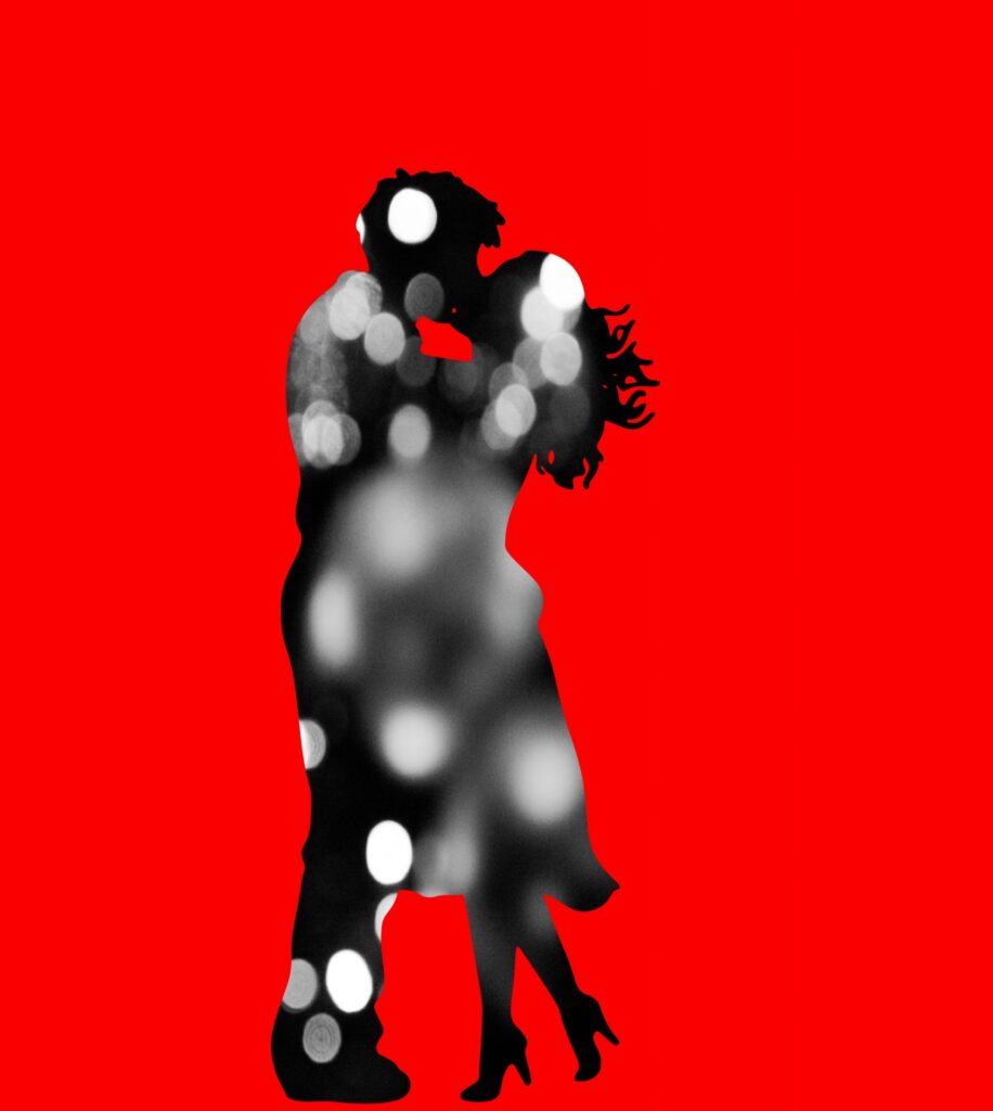 artistic rendering of a couple embracing into a kiss. Red Background, the couple is superimposed with lights.