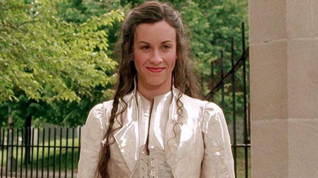 Alanis Morissette as God in Dogma wearing white and smiling