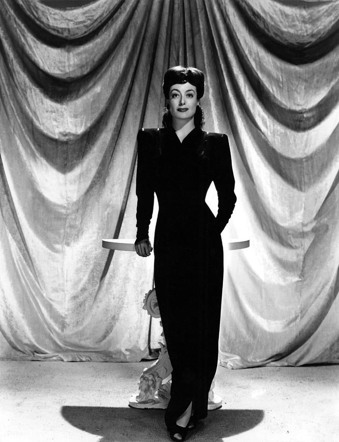 Joan Crawford in black dress with shoulderpads