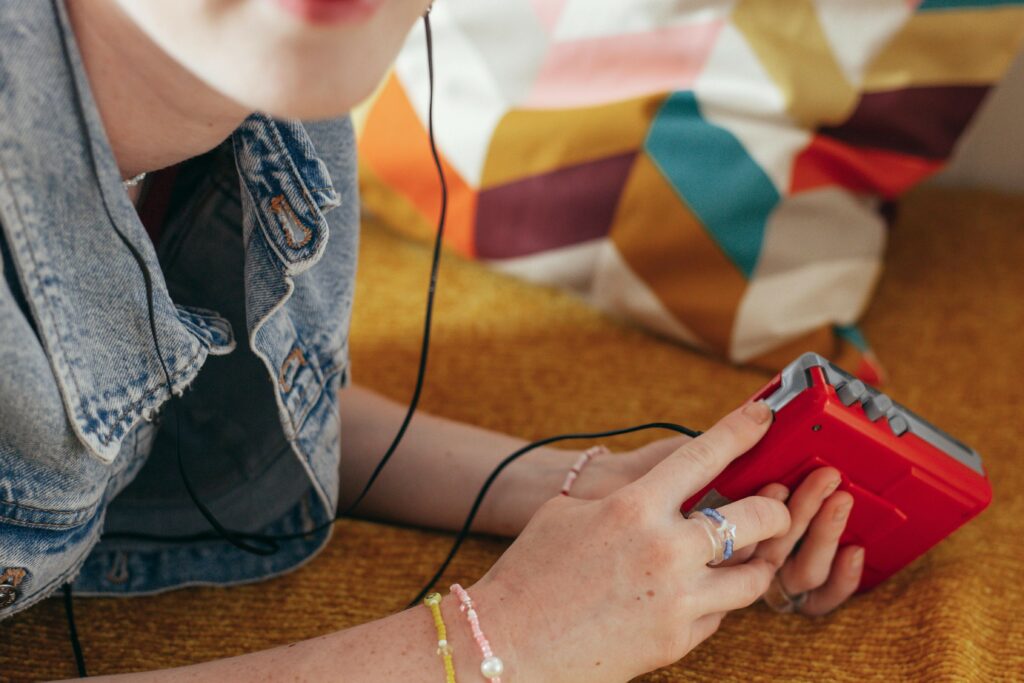 close up of woman with freckles holding a walkman