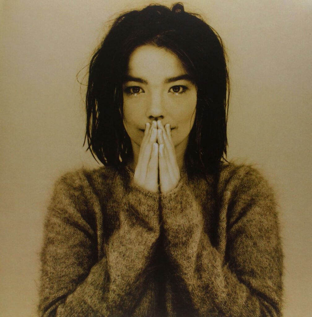 Bjork with her hands over her mouth