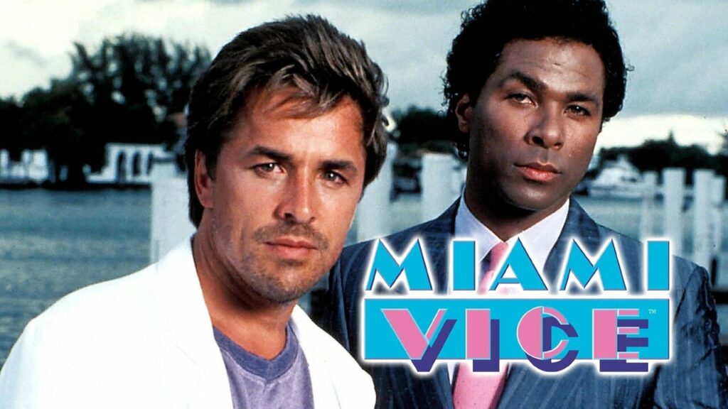 Miami Vice logo with a white man in a white suit an a black man in an expensive grey suit.