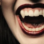 Close up of a smile with vampire fangs