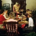 A family in the 1980s sitting over a thansgiving table.