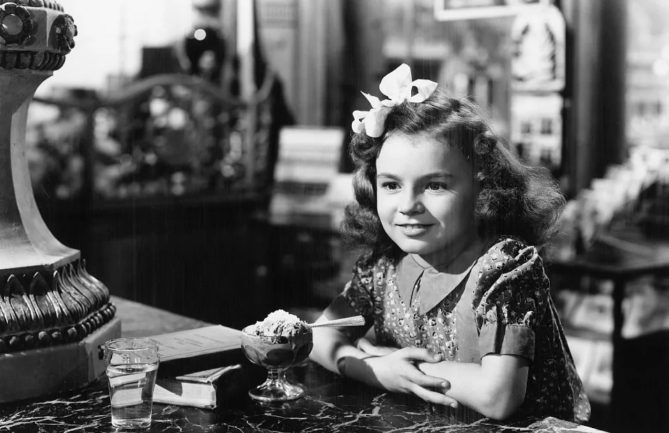 A little girl in a soda shop