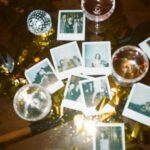 A nostalgic collection of instant photos amidst a festive party scene with wine glasses and disco decor.