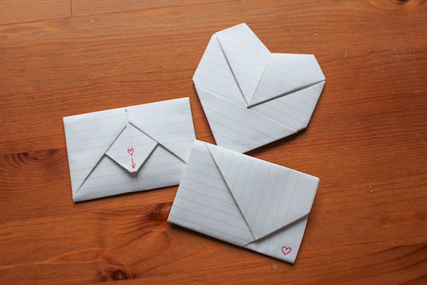 A folded note, a folded note with a pull tab, and a folded note shaped like a heart.