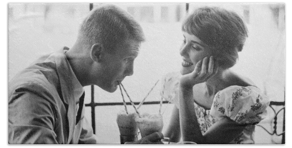 couple in the 1950's having a soda together