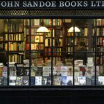 A cozy London bookstore showcasing various books through a classic window display.